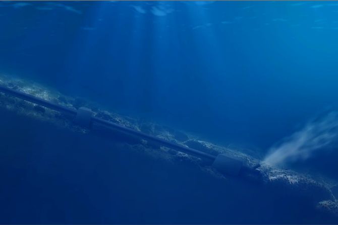 3D render of a pipeline running along the ocean floor into blue water, light shafts falling through the surface above it