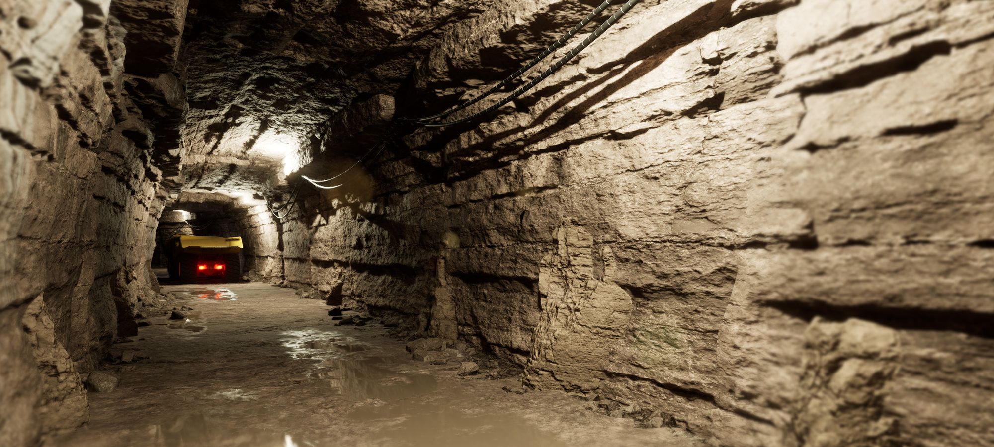 Underground mine corridor rendered in 3D, bedded rock walls lit along its length with a vehicle showing tail lights in the distance
