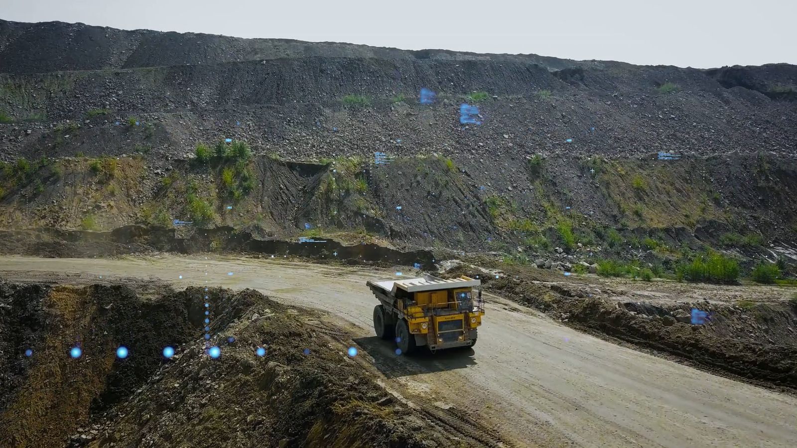 Haul truck on a road cut into the wall of an open pit