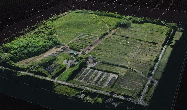 Textured 3D terrain model of the property floating on a dark measurement grid