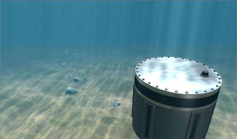 3D render of a cylindrical sonar unit resting on the sea floor in clear green-blue water, underwater caustics playing across its lid